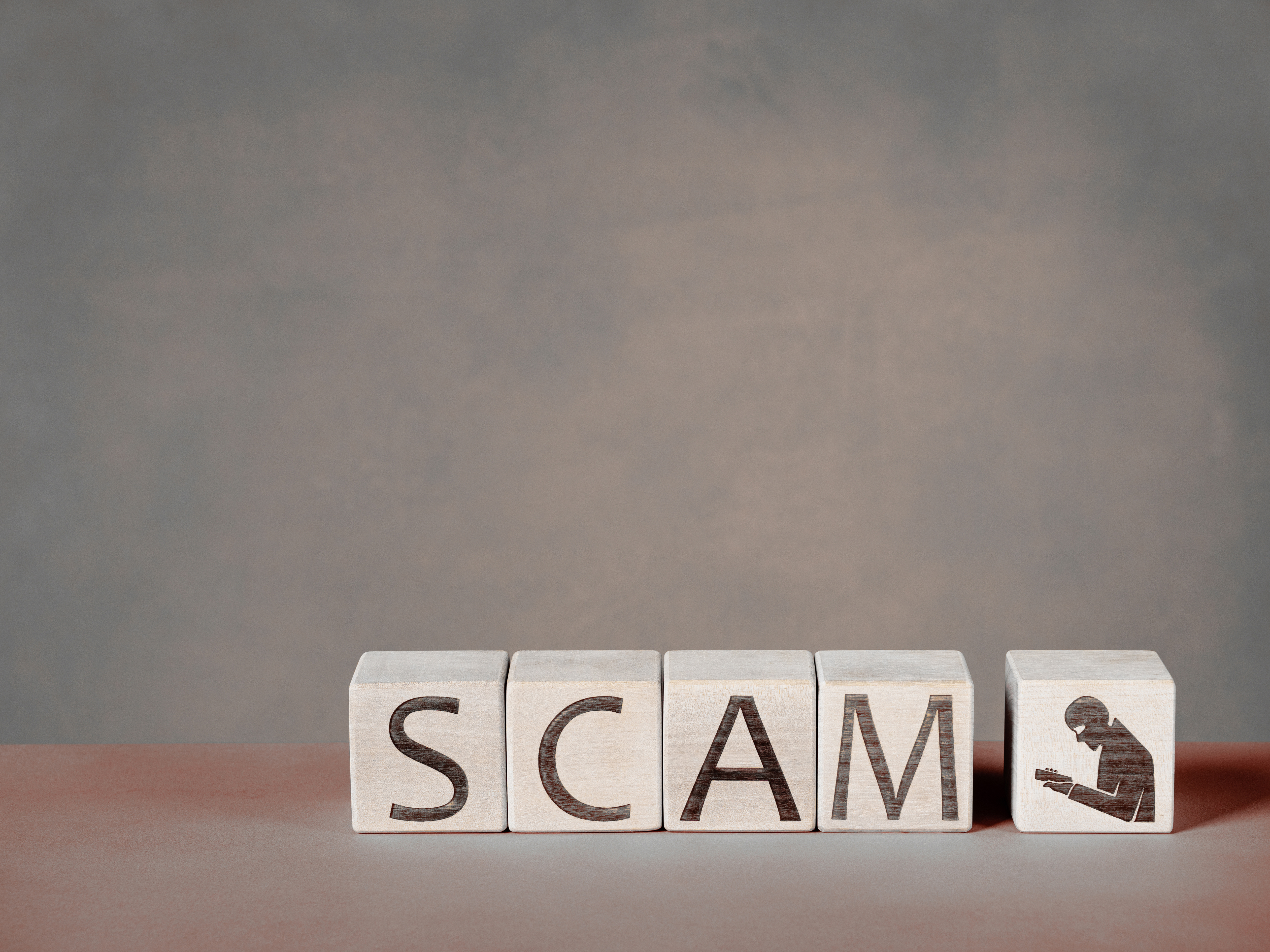 SCAM text on wood blocks as a concept of caution against predatory publishers