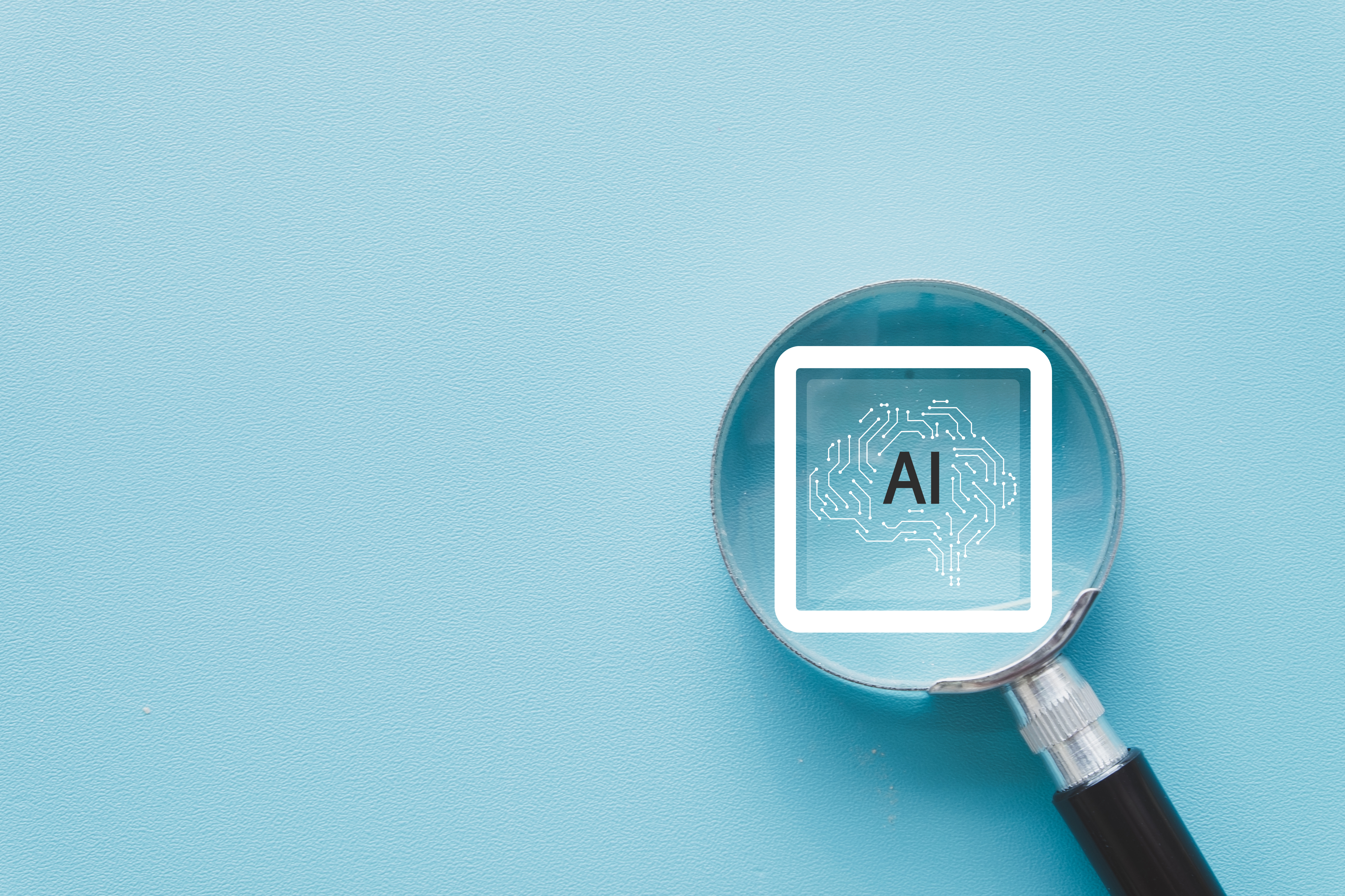 Magnifying glass focusing on the AI brain symbol with circuit lines, representing the concept of artificial intelligence, machine learning, and digital innovation on a blue background.