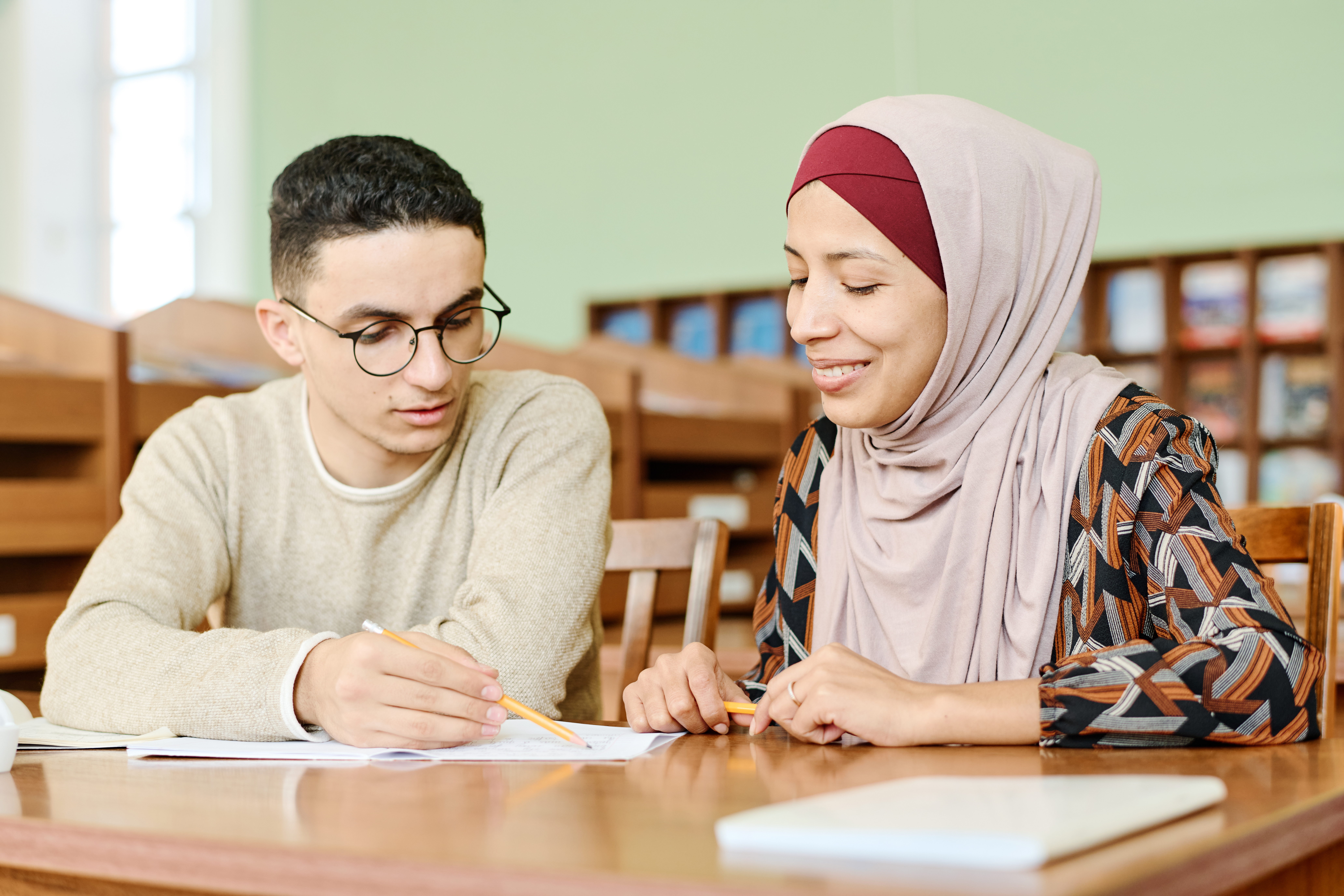 Refugee and migrant students studying together in a language classroom